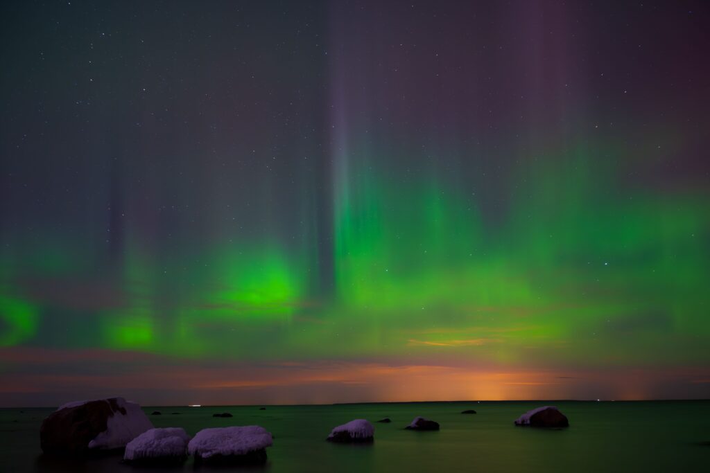 pexels-photo-34540965-34540965 Capture of vivid Northern Lights reflecting over the serene Estonian coastline.